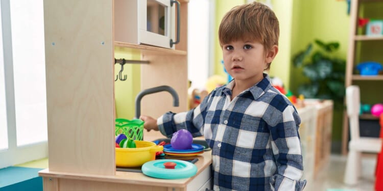 Image for article: Toddler Clocks In For Another Long Day Working In The Play Kitchen