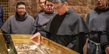 Why do the bones of St. Francis draw hundreds of thousands of pilgrims?