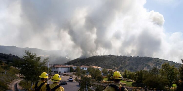 Image for article: White Smoke Rises From Los Angeles, Signaling Karen Bass Is Still Mayor