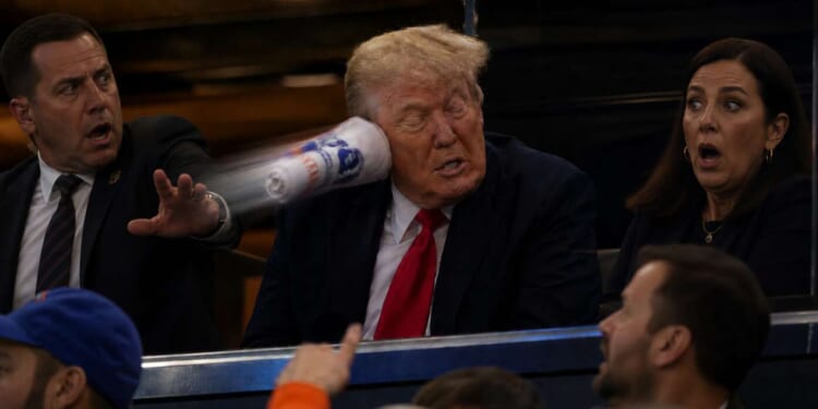 Image for article: Not Again: Trump Struck In The Ear By Shot From T-Shirt Cannon