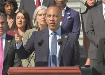 House Minority Leader Hakeem Jeffries giving a speech in front of Democratic members of Congress.